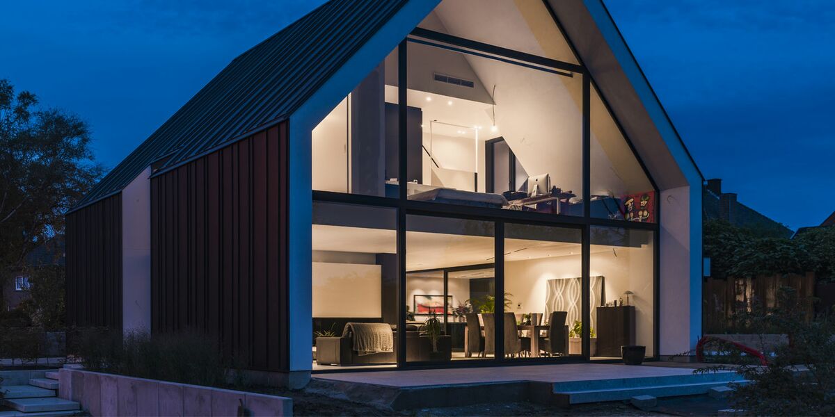 “Exterior nighttime view of private home in Bilzen, Belgium.