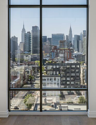 Interior view of New York penthouse, featuring floor-to-ceiling windows.